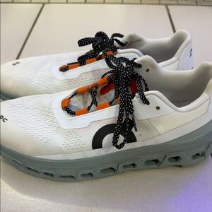 On Running White and Orange Sneakers